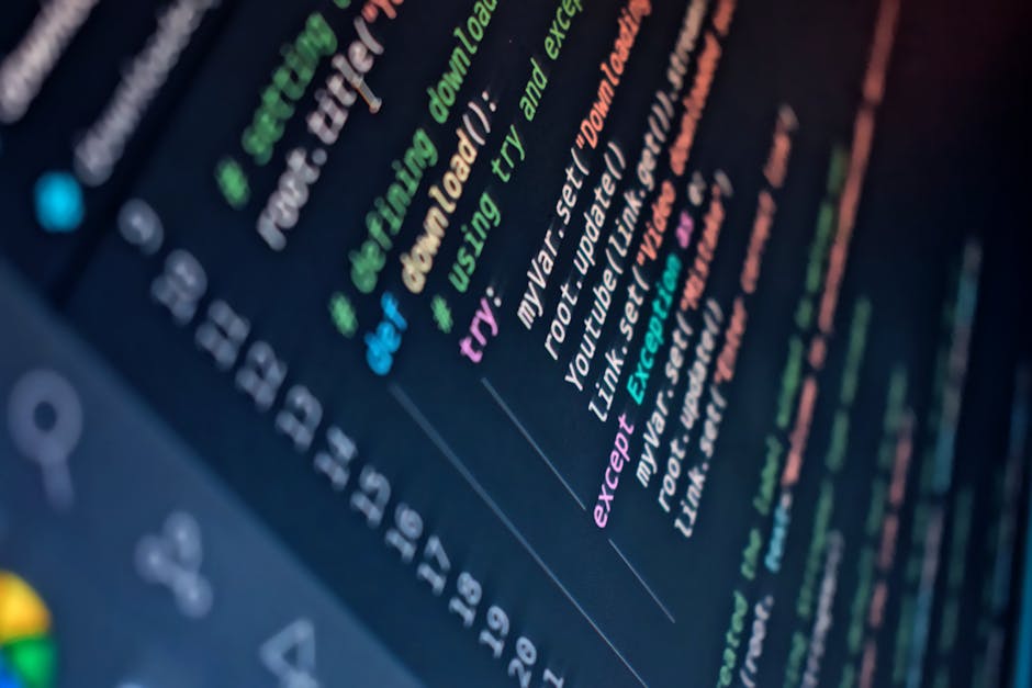 A photograph of a computer screen displaying colorful lines of code in a text editor, with keywords highlighted in shades of green, blue, purple, and orange. The code appears to be related to web deve